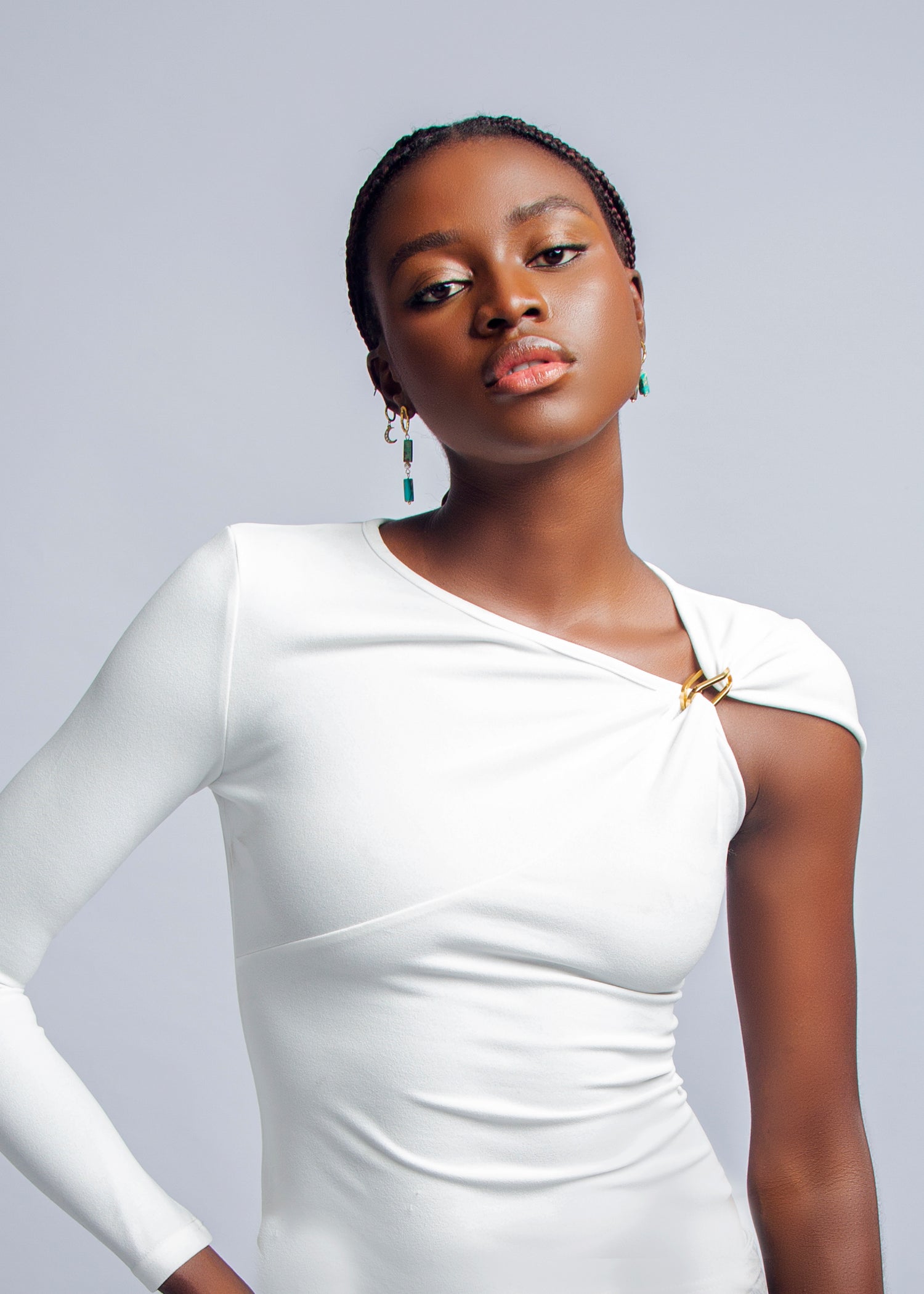 White asymmetric sleeve top with gold clasp detail